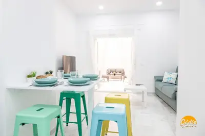 a living room with a table with stools at Casa Patio La Viña by Cadiz Time in Cádiz