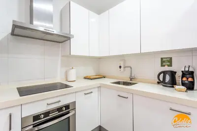 a kitchen with white cabinets and a sink at Sagasta 1750 by Cadiz Time in Cádiz