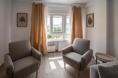 a living room with two chairs and a window at Nuevo Mirandilla Apartment - Cadiz Beach in Cádiz