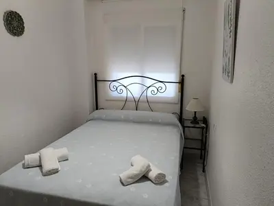 a bedroom with a bed with two towels on it at Apartamento Candari Playa en Cadiz in Cádiz