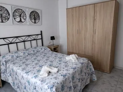 a bedroom with a bed with towels on it at Apartamento Candari Playa en Cadiz in Cádiz