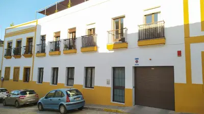a building with cars parked in front of it at Sherryflat Estudio- Parking, in Jerez de la Frontera