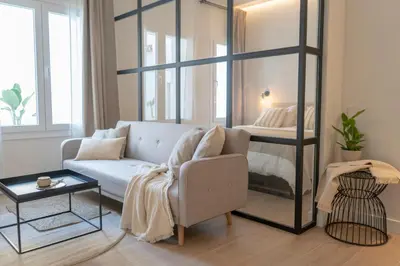 a living room with a couch and a bed at Suites Alfonso X in Jerez de la Frontera