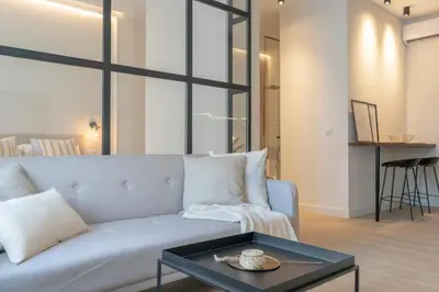 a living room with a couch and a table at Suites Alfonso X in Jerez de la Frontera