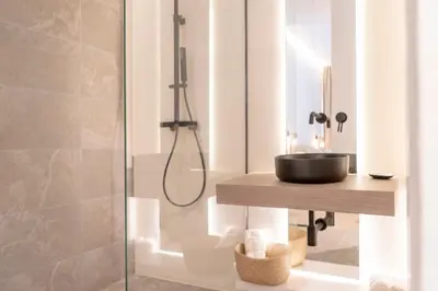 a bathroom with a sink and a shower at Suites Alfonso X in Jerez de la Frontera