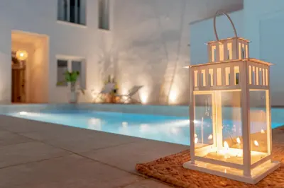 a lantern is sitting next to a swimming pool at Suites Alfonso X in Jerez de la Frontera