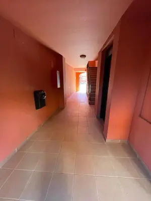 an empty hallway with orange walls and a tile floor at Apartamento Vista Hermosa en Punta Candor con piscina y Wifi in Rota