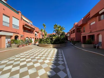 an empty street in a town with red buildings at Apartamento Vista Hermosa en Punta Candor con piscina y Wifi in Rota