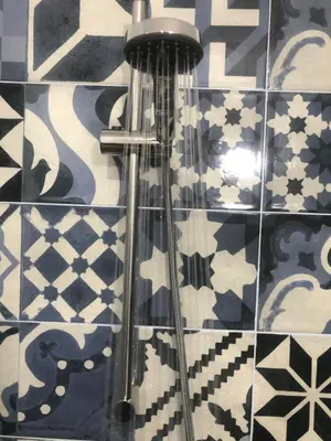 a bathroom with blue and white tiles on a wall at La Estación in Sanlúcar de Barrameda