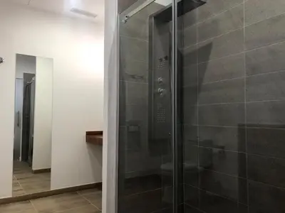a shower with a glass door in a bathroom at La Estación in Sanlúcar de Barrameda