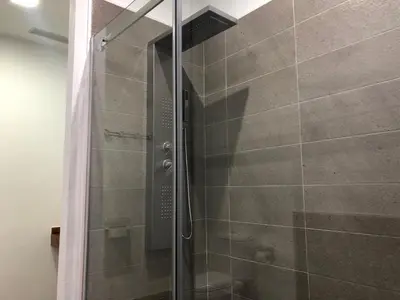 a shower with a glass door in a bathroom at La Estación in Sanlúcar de Barrameda