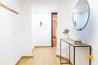 a hallway with a mirror and a table at Gallery Home by LiveWork in Cádiz