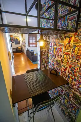 a room with a table and a wall covered in posters at SH La Casa del Capitán. Cerca de la catedral. in Cádiz