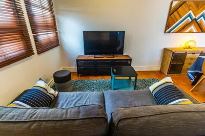 a living room with a couch and a flat screen tv at SH La Casa del Capitán. Cerca de la catedral. in Cádiz