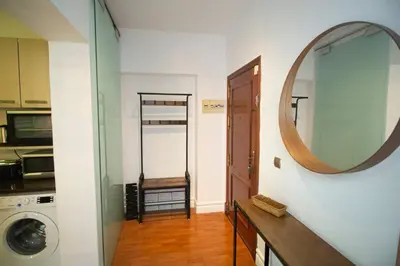 a bathroom with a mirror and a washer and dryer at SH La Casa del Capitán. Cerca de la catedral. in Cádiz