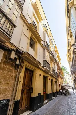 an empty street in a city with buildings at SH La Casa del Capitán. Cerca de la catedral. in Cádiz