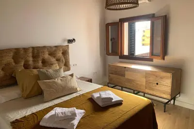 a bedroom with a large bed with two towels on it at Hidden Gem Penthouse Populo y Catedral in Cádiz