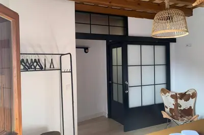 a room with a black door and a chair at Hidden Gem Penthouse Populo y Catedral in Cádiz