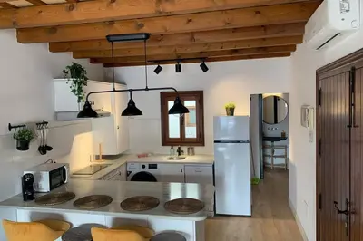a kitchen with a counter top and a refrigerator at Hidden Gem Penthouse Populo y Catedral in Cádiz