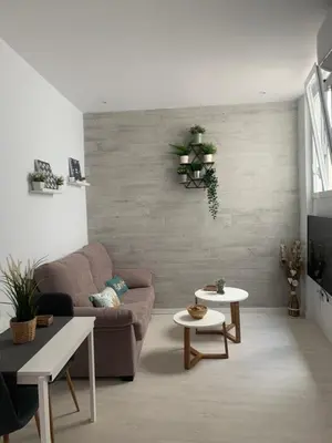a living room with a couch and two tables at Caleta Dreams. Apartamento a estrenar. A 60 metros Playa in Cádiz