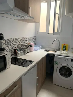 a kitchen with a sink and a washing machine at Caleta Dreams. Apartamento a estrenar. A 60 metros Playa in Cádiz