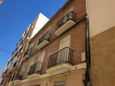 a brick building with balconies on the side of it at Caleta Dreams. Apartamento a estrenar. A 60 metros Playa in Cádiz