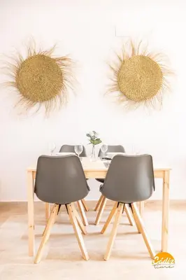 a dining room table with two black chairs at Casa Capuchinos - FREE PARKING by Cadiz Time in Cádiz