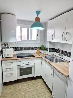 a kitchen with white cabinets and a sink at Precioso apartamento en el corazón histórico in El Puerto de Santa María