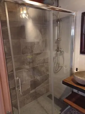 a shower with a glass door in a bathroom at Villa Tokio con jacuzzi y piscina privada in Chiclana de la Frontera