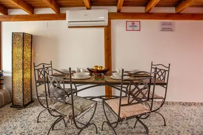 a dining room with a table and chairs at Villa Tokio con jacuzzi y piscina privada in Chiclana de la Frontera