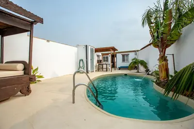a swimming pool in the backyard of a house at Villa Tokio con jacuzzi y piscina privada in Chiclana de la Frontera