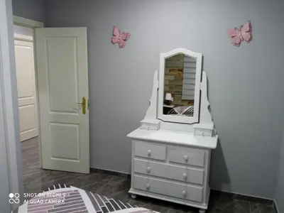 a bedroom with a dresser with a mirror on it at Casa La Maravilla in Jerez de la Frontera