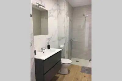 a bathroom with a sink and a toilet and a shower at Apartamento a estrenar en un lugar emblemático in Conil de la Frontera