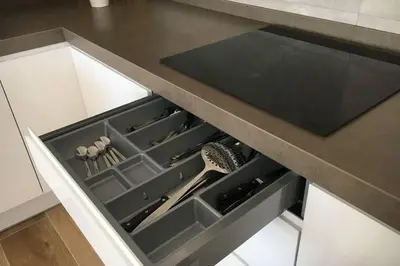 a kitchen with an open drawer with utensils at Apartamento a estrenar en un lugar emblemático in Conil de la Frontera