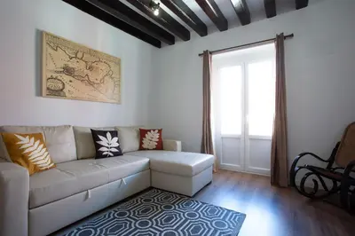 a living room with a white couch and a window at TACITA Family Home by Cadiz4Rentals in Cádiz