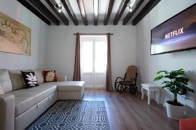 a living room with a couch and a tv at TACITA Family Home by Cadiz4Rentals in Cádiz