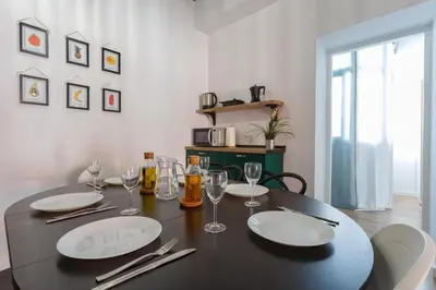 a black table with plates and wine glasses on it at TACITA Family Home by Cadiz4Rentals in Cádiz
