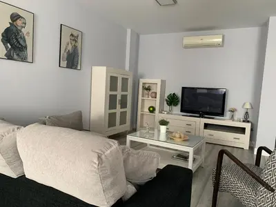 a living room with a bed and a tv at LOFT CON ENCANTO in Arcos de la Frontera