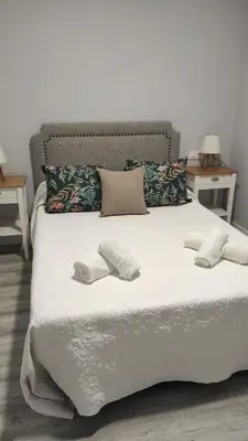 a bed with two towels and two pillows on it at LOFT CON ENCANTO in Arcos de la Frontera