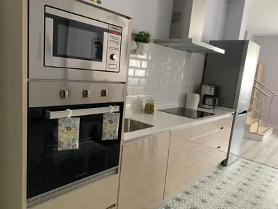 a kitchen with a microwave on top of an oven at LOFT CON ENCANTO in Arcos de la Frontera