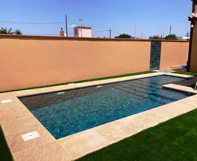 a swimming pool on the side of a building at Villa Raquel in Conil de la Frontera