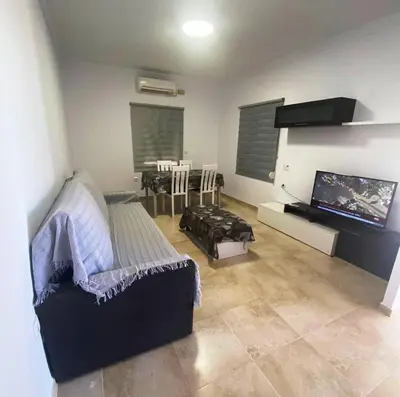 a living room with a couch and a flat screen tv at Villa Raquel in Conil de la Frontera