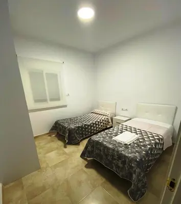a room with two beds in a room at Villa Raquel in Conil de la Frontera