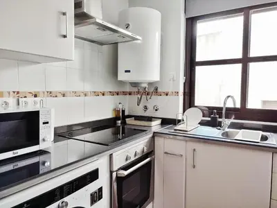 a kitchen with white appliances and a window at Jerez Centro Historico in Jerez de la Frontera