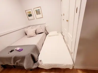 a small bed in a small room with two pillows at Jerez Centro Historico in Jerez de la Frontera