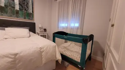 a bedroom with a bed and a chair next to a window at Jerez Centro Historico in Jerez de la Frontera