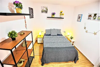 a bedroom with a bed and a desk at Plaza Noria Apartments with Balconies in El Puerto de Santa María
