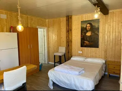 a bedroom with a bed and a painting of a woman at Casa Xeneize Punta Candor in Cádiz