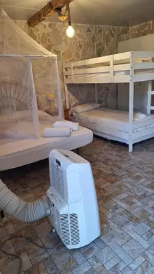 a room with two bunk beds and a computer monitor at Casa Xeneize Punta Candor in Cádiz