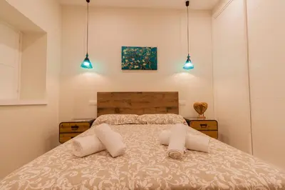 a bedroom with a bed with two pillows on it at Apartamento - Patio 1812 in Cádiz